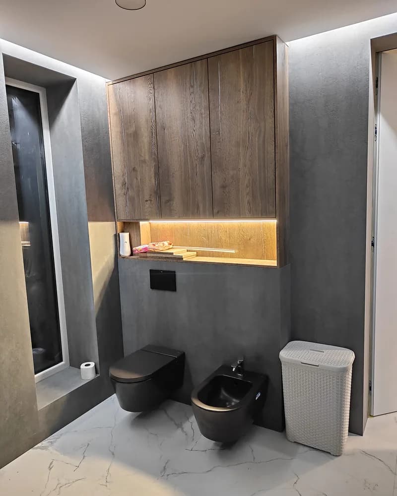 Walnut wall-mounted bathroom cabinetry with integrated lighting