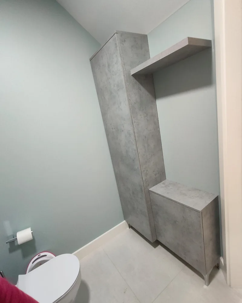 Space-saving concrete-effect bathroom cabinetry with a tall storage unit