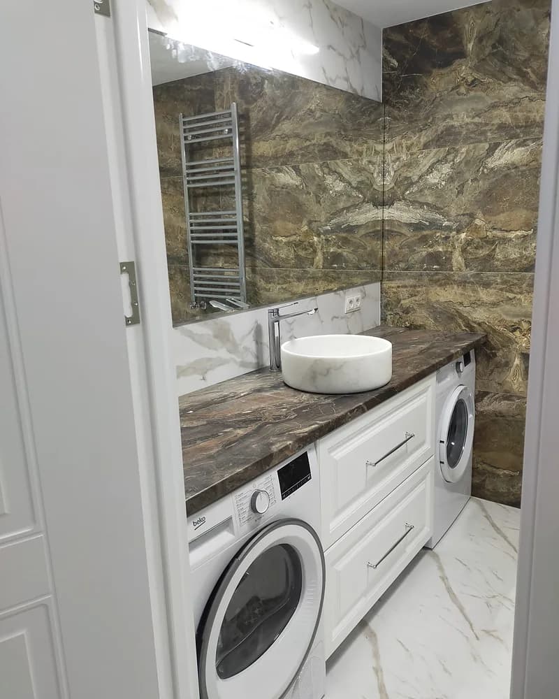 Custom white utility and vanity units fitted around a washing machine and dryer