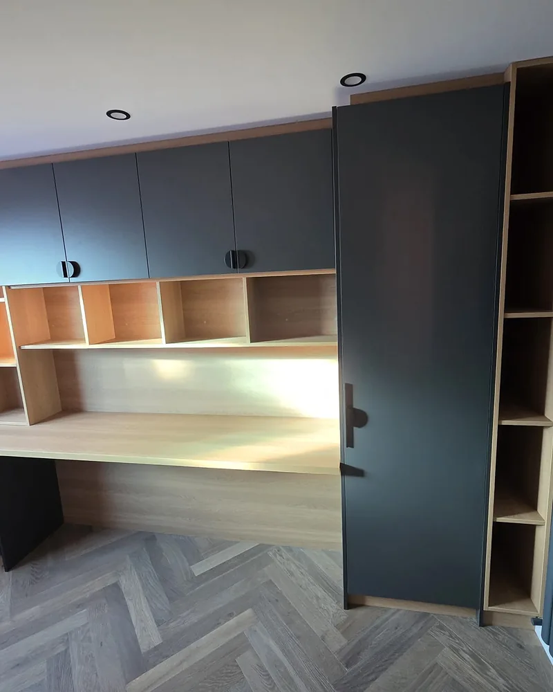 Bespoke fitted home office with a full-width desk, shelving and dark cabinetry