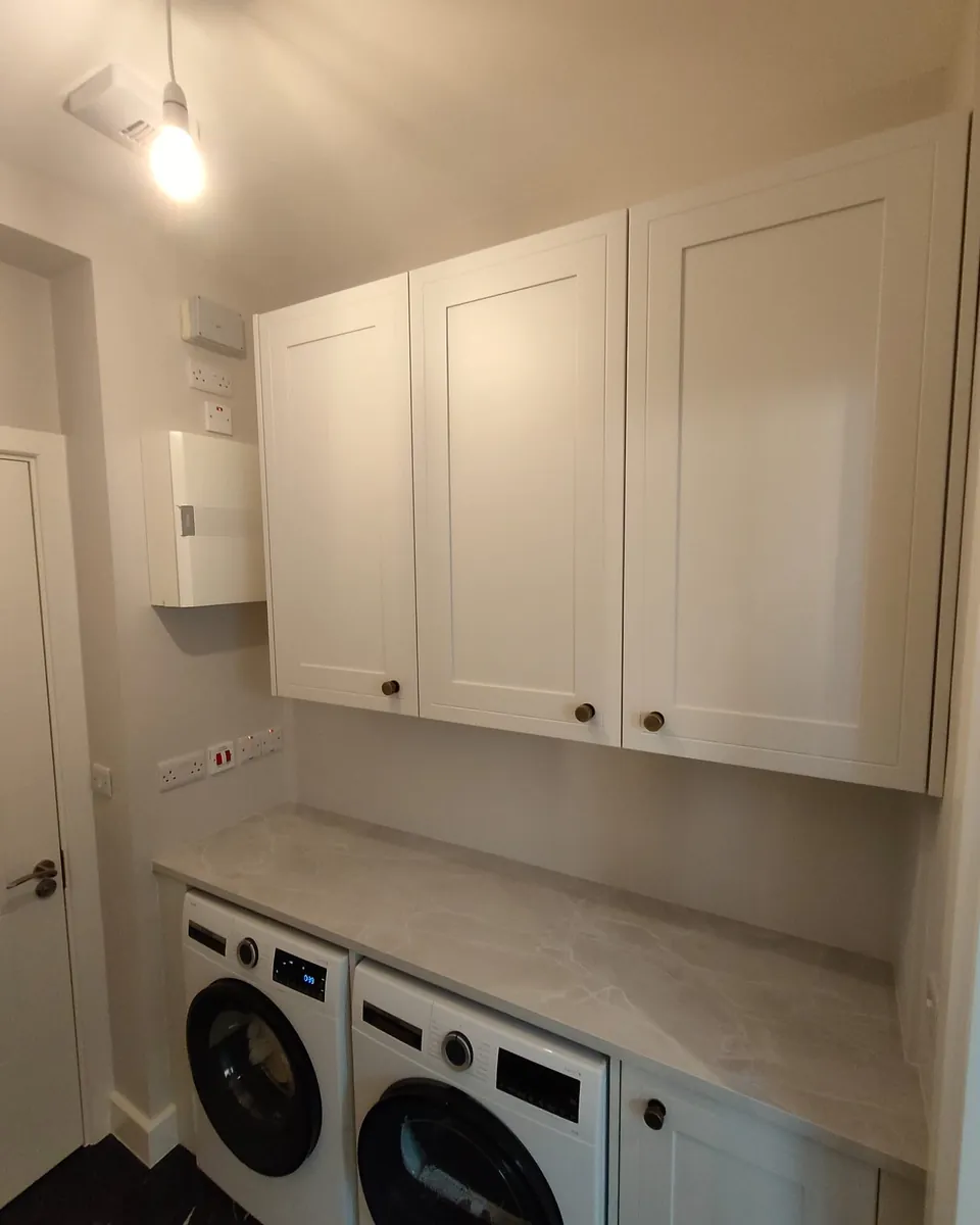 Made-to-measure utility room cabinets above a stone-effect worktop