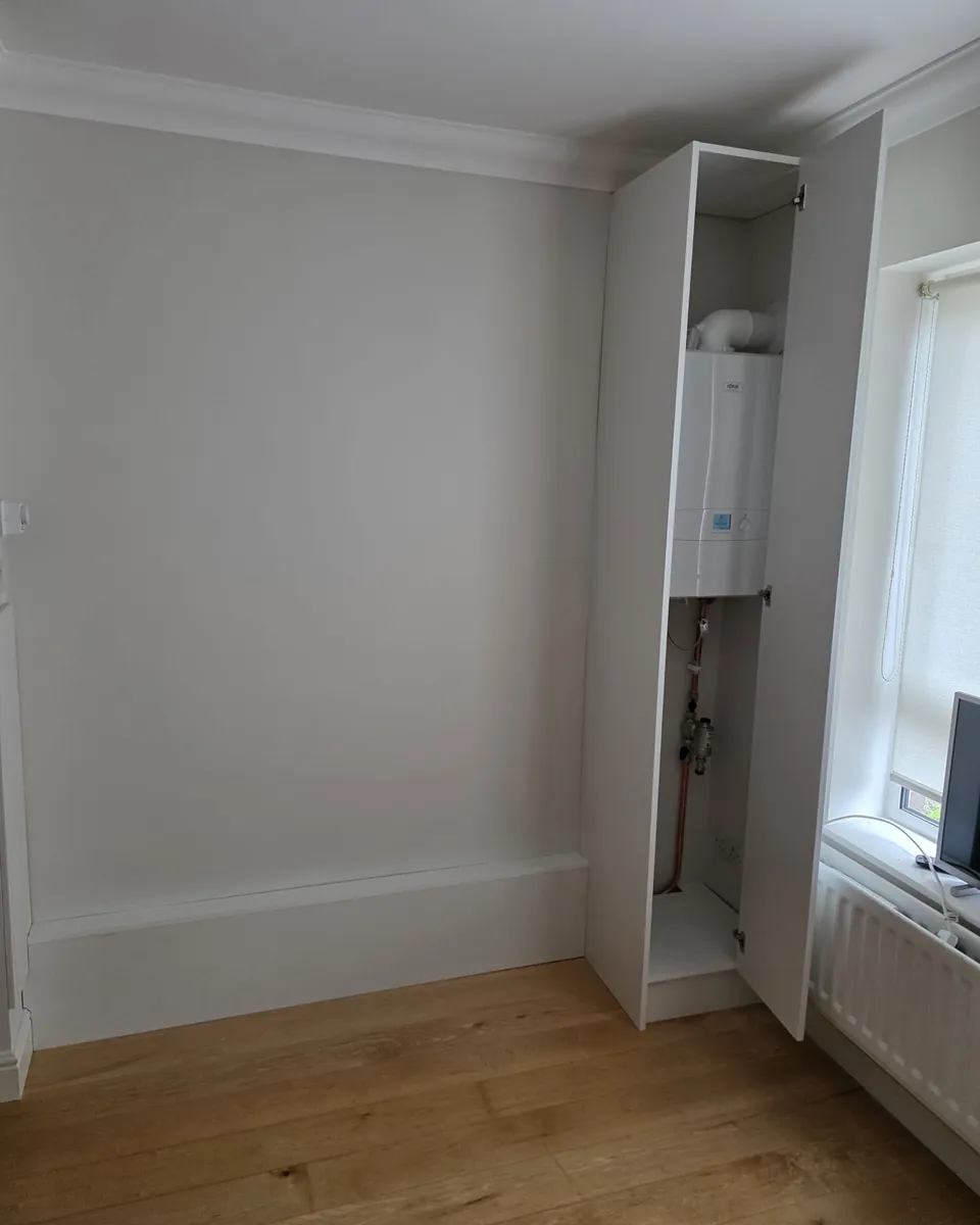 Open fitted boiler cupboard designed to use a narrow utility room space