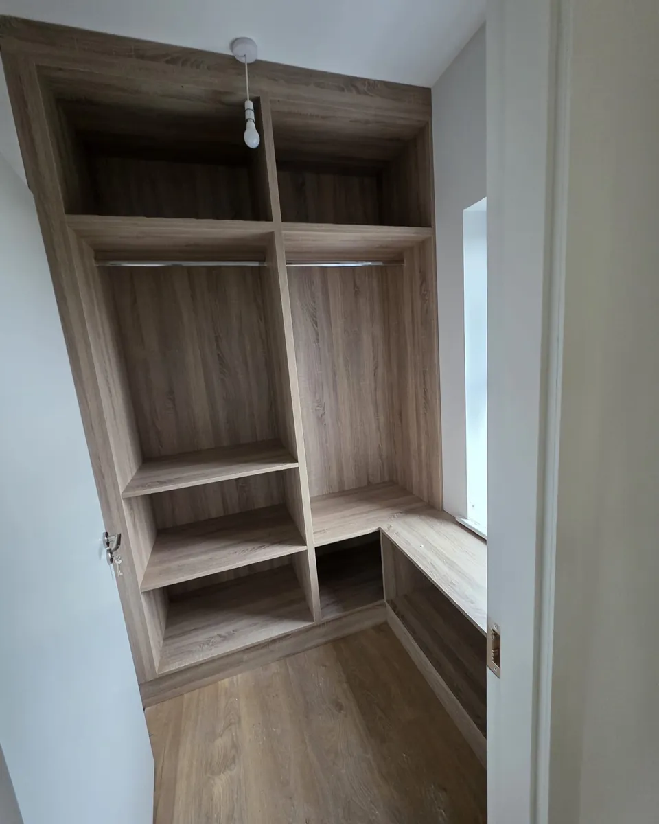 Made-to-measure timber-effect walk-in storage with hanging rails and shelves