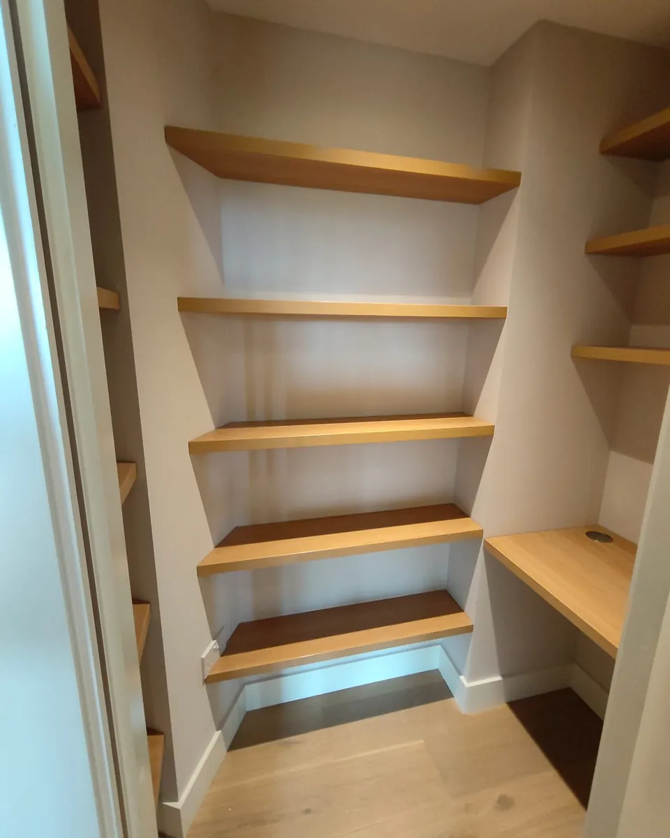 Custom pantry shelving with an integrated timber work surface